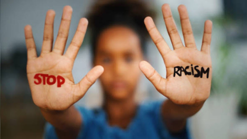 stop racism written on hands